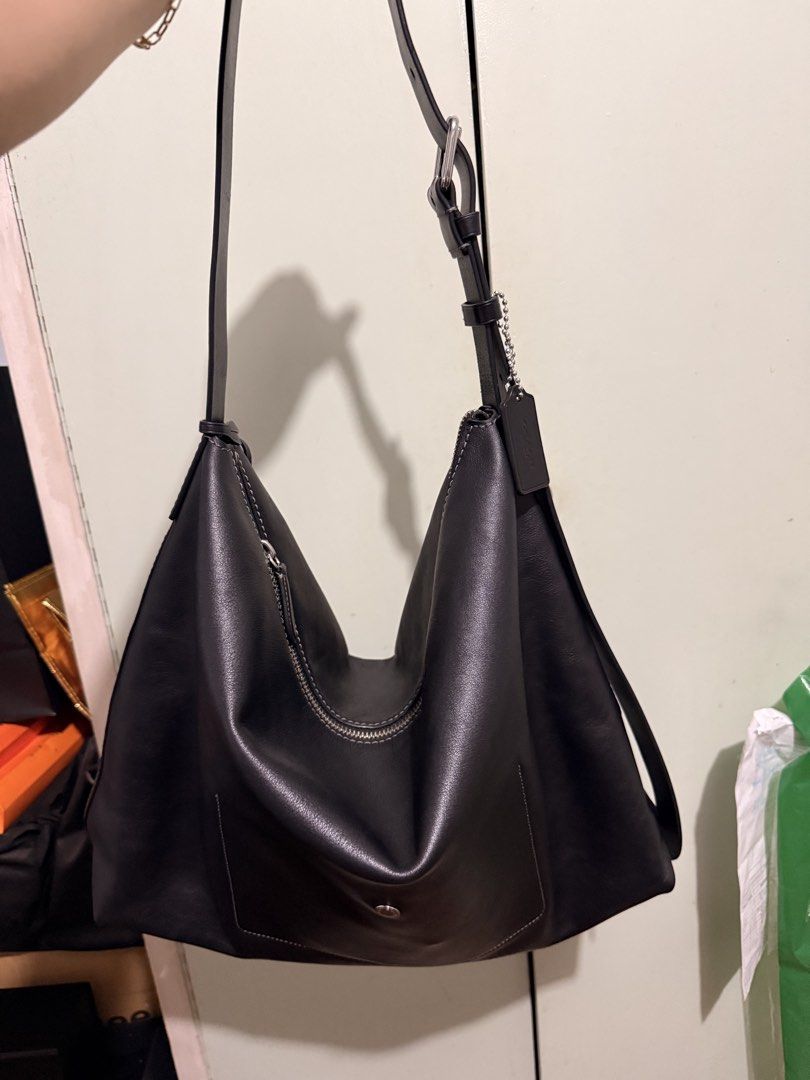 Coach Black Leather Shoulder Bag Hobo (Category: Luxury Bags & Wallets) located in San Juan City. Submitted by zenrabbit.6105c7 (Listing ID 1464691399, Image 2). Description: - Brand: Coach - Color: Classic black - Material: Genuine leather with slouchy drape - Hardware: Silver-tone zippers and accents - Strap: Adjustable with buckle - Features: Secure zip closure, open main compartment, and matching leather hangtag - Style: Minimalist and versat