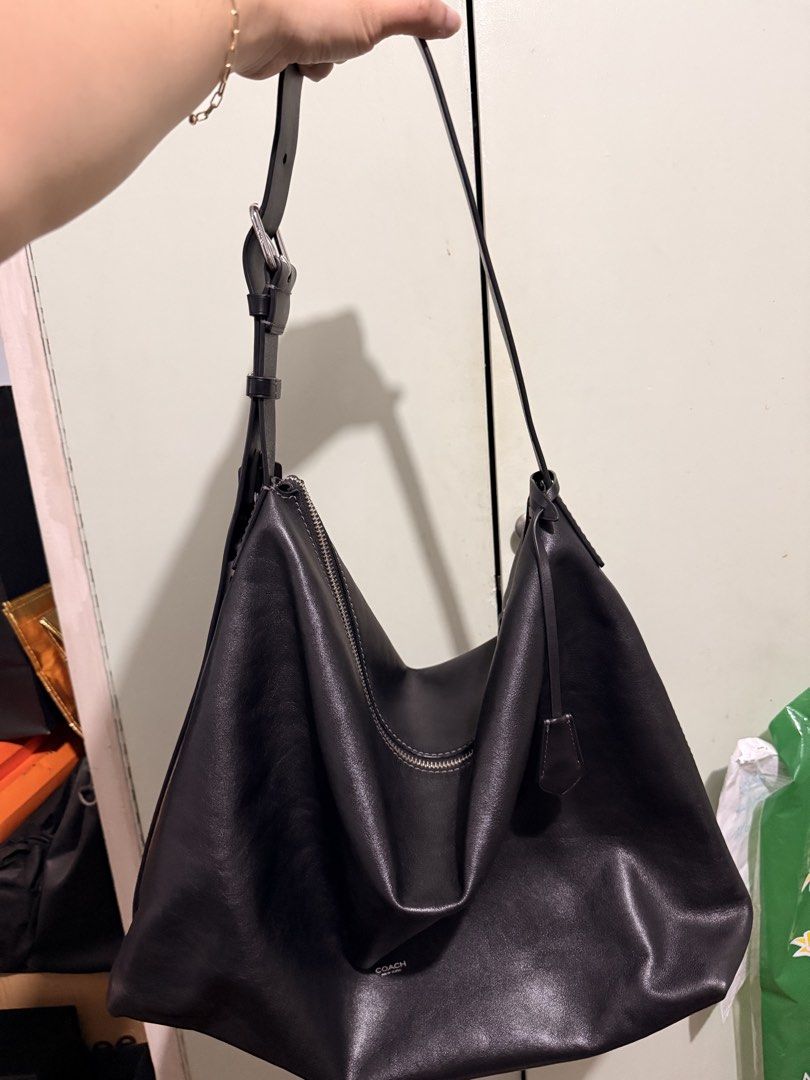 Coach Black Leather Shoulder Bag Hobo (Category: Luxury Bags & Wallets) located in San Juan City. Submitted by zenrabbit.6105c7 (Listing ID 1464691399, Image 1). Description: - Brand: Coach - Color: Classic black - Material: Genuine leather with slouchy drape - Hardware: Silver-tone zippers and accents - Strap: Adjustable with buckle - Features: Secure zip closure, open main compartment, and matching leather hangtag - Style: Minimalist and versat