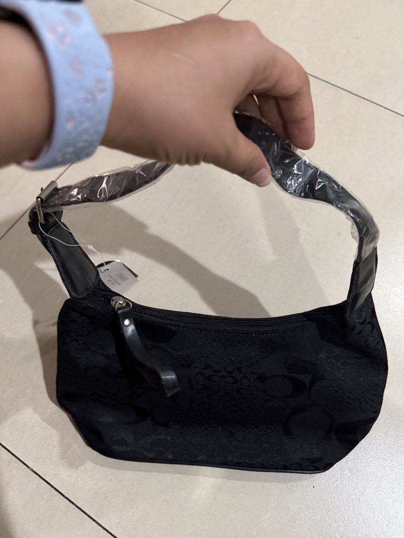 Coach Black Monogram Shoulder Bag (Category: Luxury Bags & Wallets) located in Manila. Submitted by metrosen (Listing ID 1464584408, Image 2). Description: - Authentic Coach shoulder bag - Classic Coach monogram pattern - Leather trim and strap - Zippered main compartment - Front zippered pocket - Brand new with original tags attached - Ideal size for everyday essentials.
