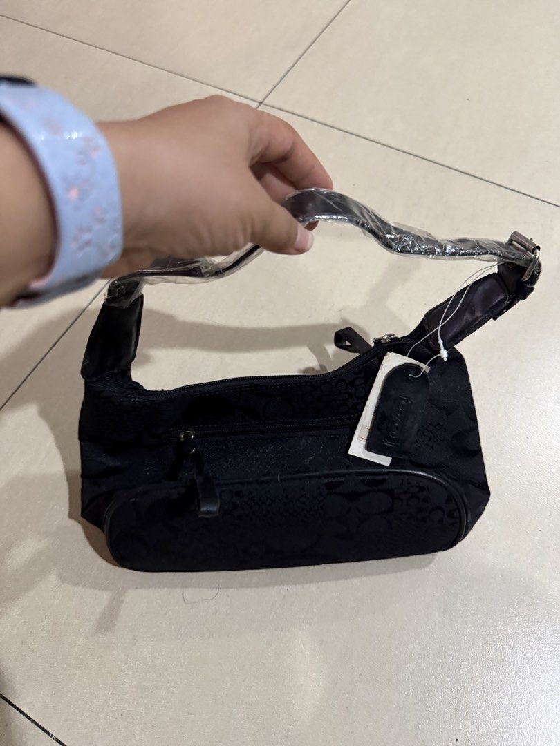 Coach Black Monogram Shoulder Bag (Category: Luxury Bags & Wallets) located in Manila. Submitted by metrosen (Listing ID 1464584408, Image 1). Description: - Authentic Coach shoulder bag - Classic Coach monogram pattern - Leather trim and strap - Zippered main compartment - Front zippered pocket - Brand new with original tags attached - Ideal size for everyday essentials.