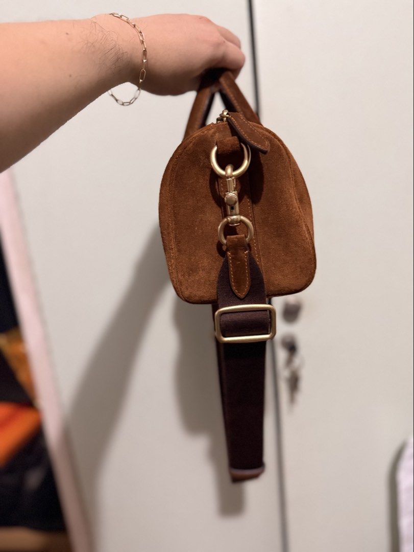 Coach Brown Suede Compass Bag with Strap (Category: Luxury Bags & Wallets) located in San Juan City. Submitted by zenrabbit.6105c7 (Listing ID 1464691271, Image 3). Description: - Authentic Coach suede compass bag in a rich brown shade - Elegant gold hardware details and classic Coach New York front logo - Includes matching top handles and a thick, adjustable dark brown crossbody strap - Secure top zipper closure - Complete with the signature lea