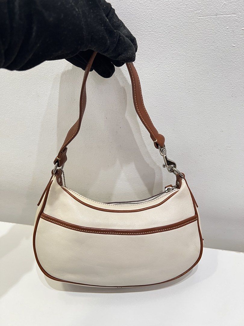 Coach Hampton Demi Y2K Baguette Bag (Category: Luxury Bags & Wallets) located in Cebu City. Submitted by brandedcorner_ph (Listing ID 1464726994, Image 2). Description: Pre-loved ((C))oach Hampton Demi Y2K Baguette Bag 100% Authentic or money back Condition • Excellent condition • No flaws Product Details •Color: White •Hardware: Silver tone •Material: Leather •Approximate Dimensions in inches: H5 x W9.5 x D2 Color may vary due to lighting. PM fo