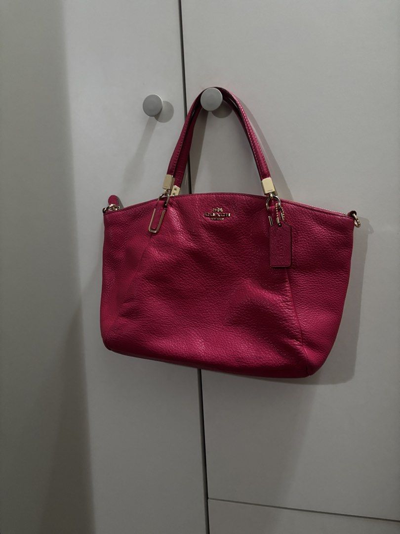 Coach Hot Pink Leather Bag (Category: Luxury Bags & Wallets) located in Manila. Submitted by estebannika35 (Listing ID 1464747660, Image 2). Description: - Authentic Coach leather bag in a vibrant bright pink shade - Luxurious gold hardware and signature Coach hangtag included - Secure top zip closure with comfortable dual shoulder straps - Durable pebbled leather texture - Medium size with plenty of room for your daily essentials - Impeccable co