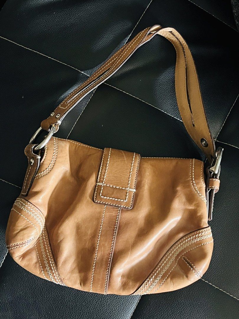 Coach Leather Shoulder Bag (Category: Luxury Bags & Wallets) located in Malolos. Submitted by magnoannchrstn (Listing ID 1464619263, Image 2). Description: - Coach brown leather shoulder bag - Classic design with secure buckle closure - Features an interior zip pocket for essentials - Ideal for everyday use - Serial number: L0682-10577.