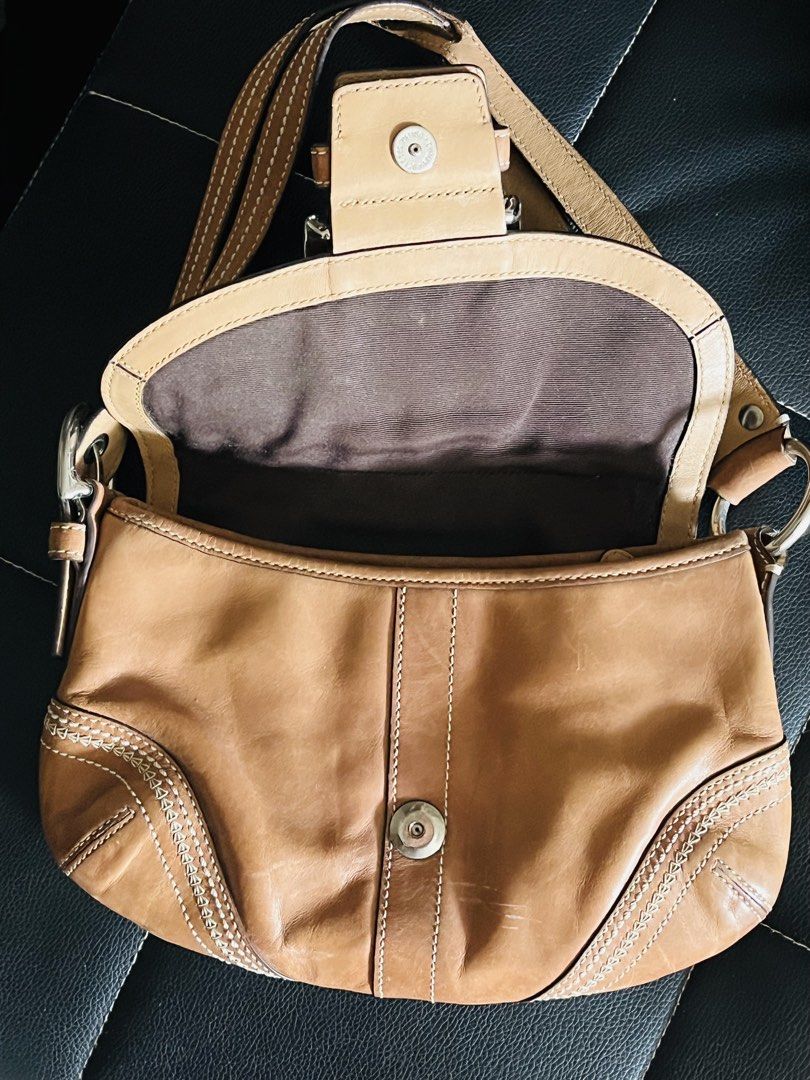 Coach Leather Shoulder Bag (Category: Luxury Bags & Wallets) located in Malolos. Submitted by magnoannchrstn (Listing ID 1464619263, Image 3). Description: - Coach brown leather shoulder bag - Classic design with secure buckle closure - Features an interior zip pocket for essentials - Ideal for everyday use - Serial number: L0682-10577.