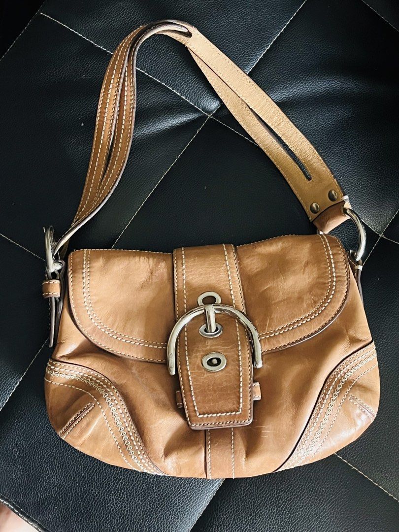 Coach Leather Shoulder Bag (Category: Luxury Bags & Wallets) located in Malolos. Submitted by magnoannchrstn (Listing ID 1464619263, Image 1). Description: - Coach brown leather shoulder bag - Classic design with secure buckle closure - Features an interior zip pocket for essentials - Ideal for everyday use - Serial number: L0682-10577.