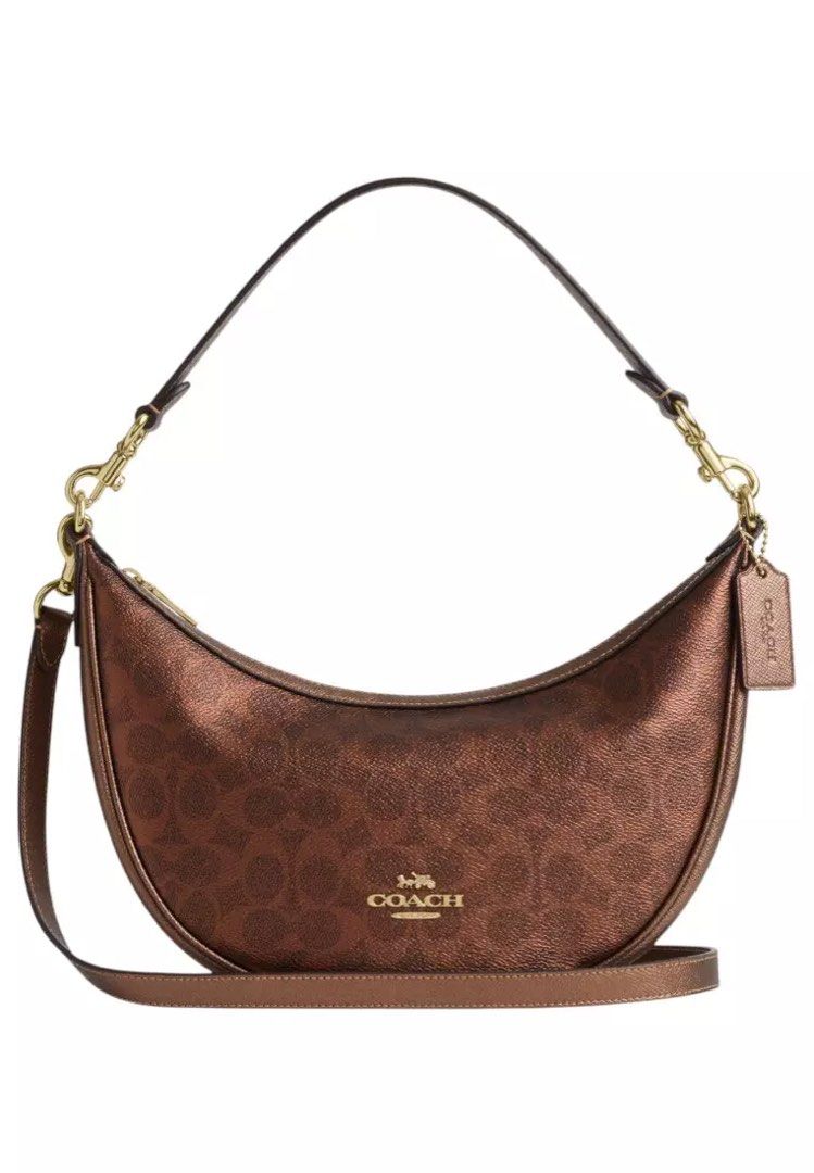 Coach Metallic Brown Copper Aria Half Moon Shoulder Bag (Category: Shoulder Bags) located in Caloocan City. Submitted by dearvals (Listing ID 1463966899, Image 2). Description: - Coach crescent shoulder bag - Metallic brown with subtle texture - Gold hardware and front Coach logo - Adjustable strap - Brand new with original tags attached - Versatile for everyday or evening wear.
