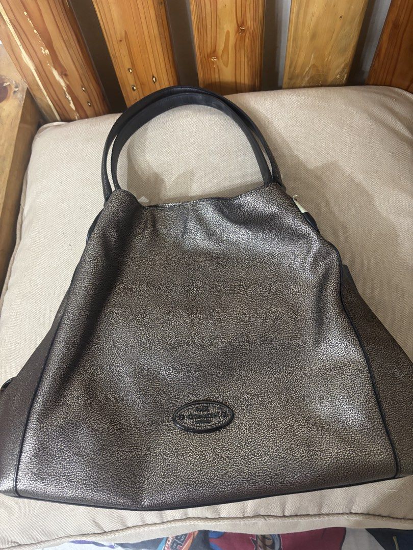 Coach Metallic Hobo Shoulder Bag (Category: Shoulder Bags) located in Famy. Submitted by frenchmacaroon (Listing ID 1464595504, Image 1). Description: - Genuine leather Coach hobo bag - Chic metallic bronze color - Secure zipper closure on top - Multiple interior pockets for organization - Comes with original dust bag - Ideal everyday bag Can pass as brandnew Unused.