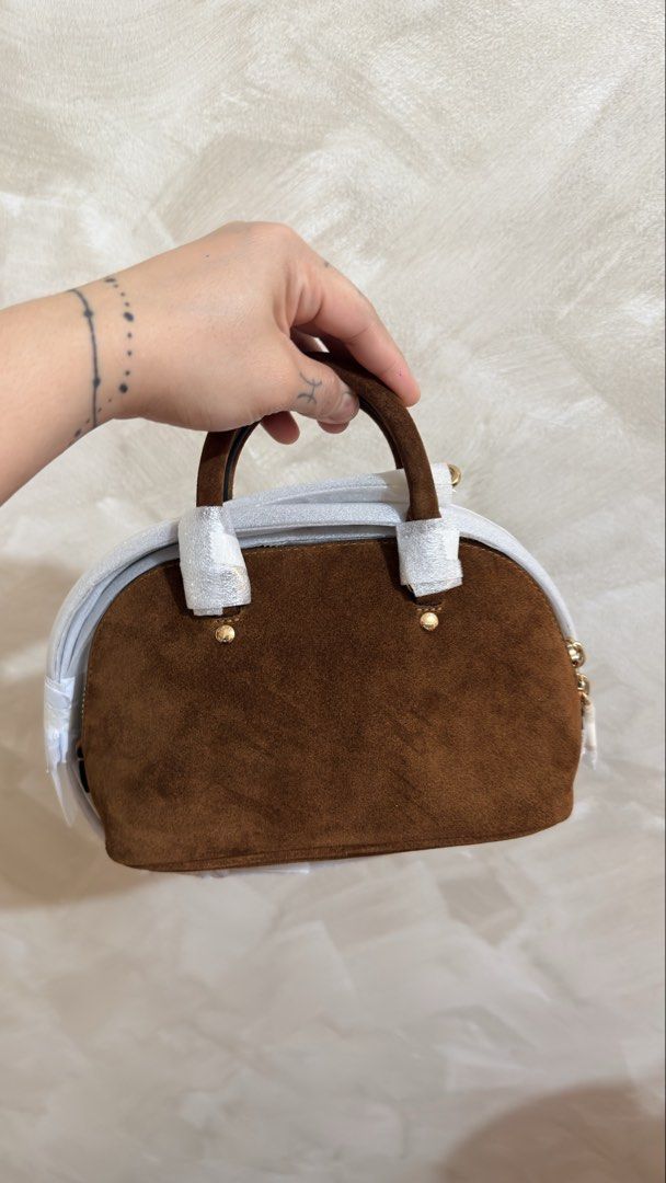Coach Mini Lara (Category: Cross-body Bags) located in Las Pinas. Submitted by mharjrahm (Listing ID 1464732856, Image 2). Description: - Brand: Coach - Style: Brown suede mini satchel - Condition: brandnew with original packing materials still attached - Hardware: Gold-tone with front signature logo lettering - Handles: Top grab handles and a long shoulder strap (still wrapped in protective paper) - Inclusion: Original leather hangtag laspiñas l