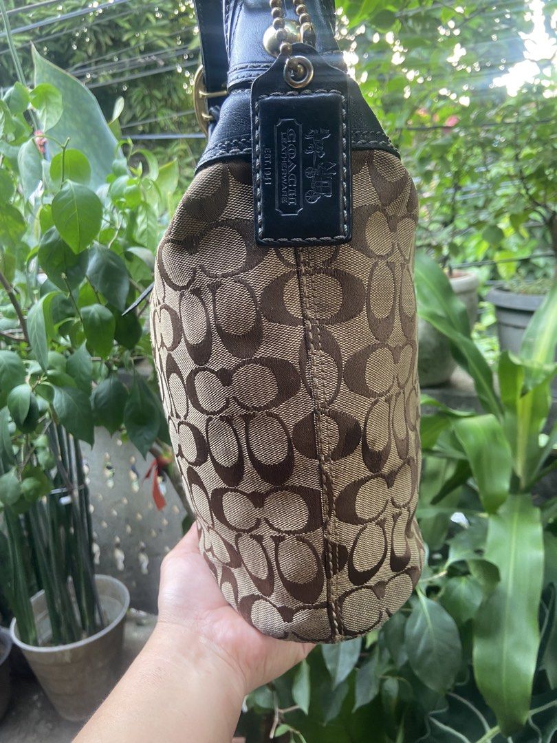 Coach Monogram Canvas Leather Hobo Shoulder Bag (Category: Luxury Bags & Wallets) located in Rizal. Submitted by baglovers10 (Listing ID 1464647395, Image 3). Description: - Classic Coach hobo bag - Signature monogram canvas with black leather trim - Gold hardware details - Adjustable shoulder strap with buckle - Spacious interior for essentials - Timeless piece for everyday use With pen stain s pocket .