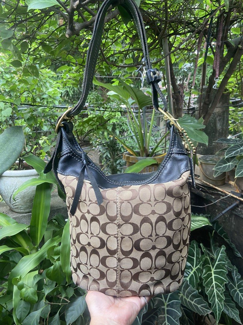 Coach Monogram Canvas Leather Hobo Shoulder Bag (Category: Luxury Bags & Wallets) located in Rizal. Submitted by baglovers10 (Listing ID 1464647395, Image 1). Description: - Classic Coach hobo bag - Signature monogram canvas with black leather trim - Gold hardware details - Adjustable shoulder strap with buckle - Spacious interior for essentials - Timeless piece for everyday use With pen stain s pocket .