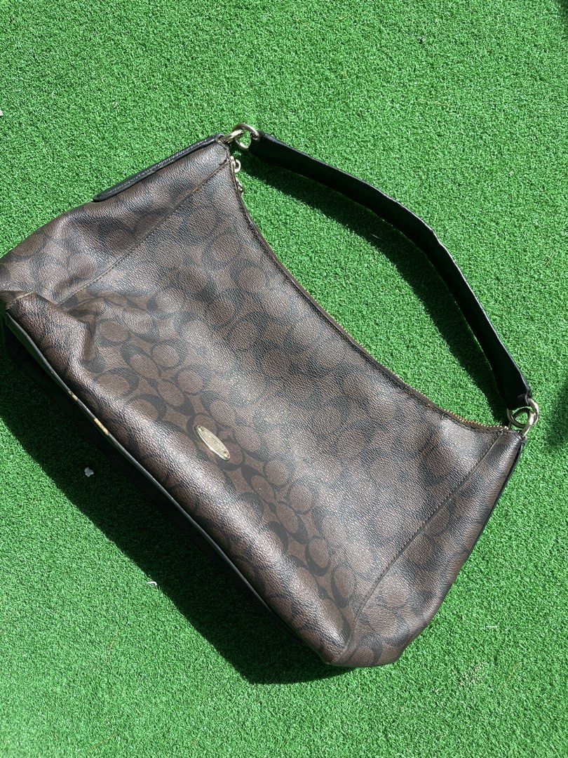 Coach Monogram Shoulder Bag (Category: Luxury Bags & Wallets) located in Cagayan de Oro. Submitted by charlessober (Listing ID 1464579995, Image 2). Description: - Classic Coach shoulder bag - Dark brown with signature monogram pattern - Black leather strap and trim - Zipper closure - Versatile for everyday use - Shows some signs of wear on strap and edges - Still in good shape with plenty of life left.