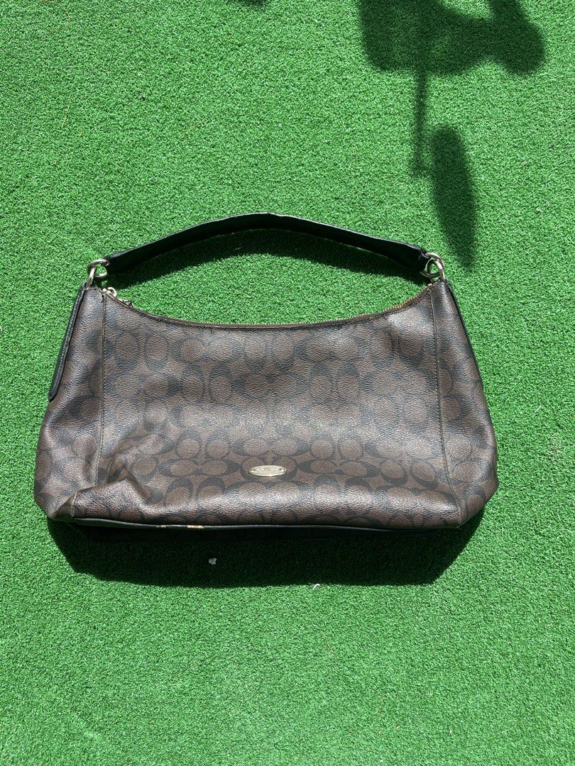Coach Monogram Shoulder Bag (Category: Luxury Bags & Wallets) located in Cagayan de Oro. Submitted by charlessober (Listing ID 1464579995, Image 1). Description: - Classic Coach shoulder bag - Dark brown with signature monogram pattern - Black leather strap and trim - Zipper closure - Versatile for everyday use - Shows some signs of wear on strap and edges - Still in good shape with plenty of life left.
