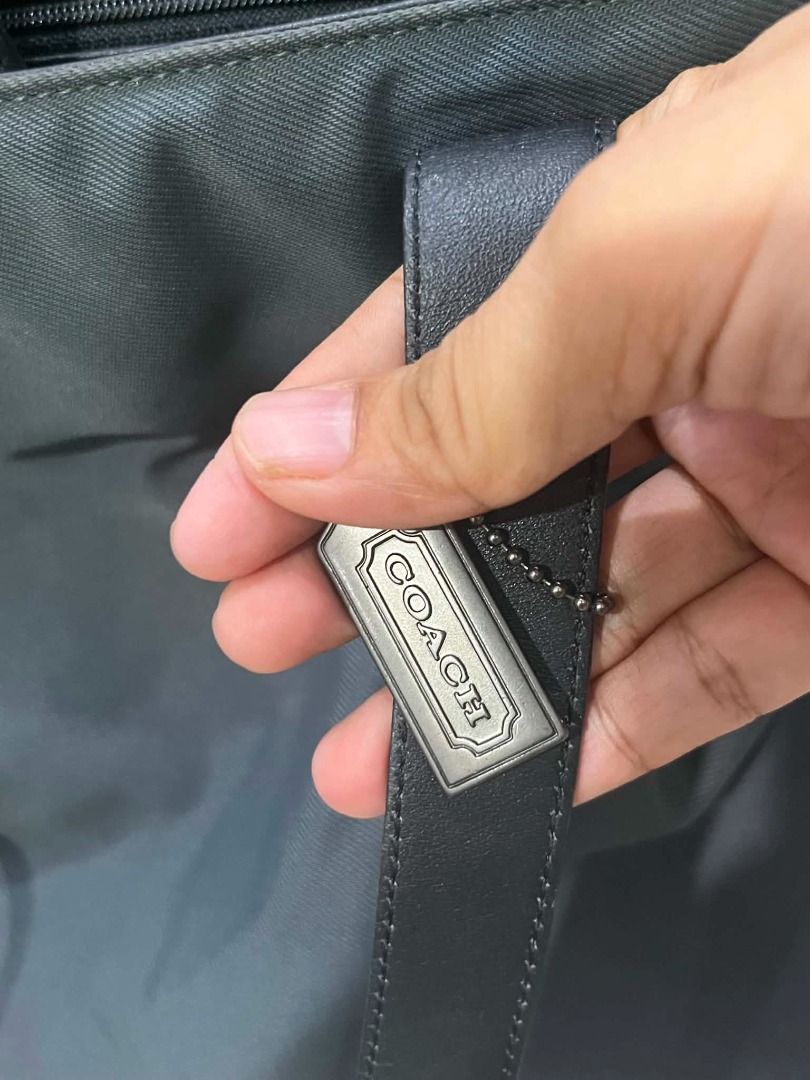 Coach New York Tote Bag (Category: Tote Bags) located in Imus. Submitted by muega052638810 (Listing ID 1464626314, Image 2). Description: - Classic Coach tote bag - Durable nylon fabric with genuine leather trim - Interior pockets for easy organization - Elegant silver hardware details - Ideal for everyday use - Model number: G9K-7402.