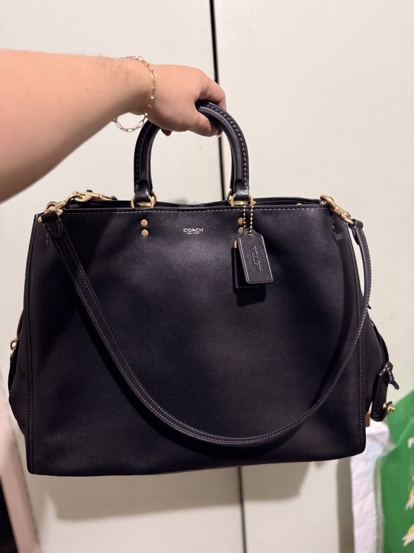 Coach Rogue Black Leather Tote Bag (Category: Luxury Bags & Wallets) located in San Juan City. Submitted by zenrabbit.6105c7 (Listing ID 1464691379, Image 1). Description: - Brand: Coach Rogue Bag - Color/Material: Classic black leather with brass hardware - Carry options: Top handles and detachable shoulder strap - Compartments: Structured sides with secure zippered compartments - Condition: Clean inside and out, solid construction - Extras: Sig