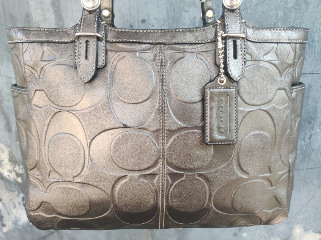Coach Satchel Tote Bag (Category: Luxury Bags & Wallets) located in Naguilian. Submitted by a2aonlineshop (Listing ID 1464625028, Image 2). Description: Style: F15242 Color: Mettalic Charcoal Gray Material: Gunmetal Leather with an embossed signature C Size:11x9x3.5 inches (WxHxD) Issue: Discoloration, visible Po sa mga photos leather & rubber lining is in great condition, satin lining is neat..