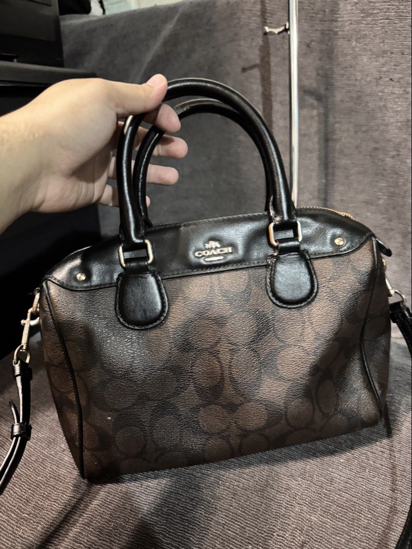 Coach Signature Monogram Brown Leather Handbag (Category: Luxury Bags & Wallets) located in Manila. Submitted by dearpinkcollections (Listing ID 1464682247, Image 2). Description: - Classic Coach monogram print handbag - Brown and black colorway - Genuine leather trim and handles - Secure zipper closure/ puller issue /slightly tarnish side sling - Detachable shoulder strap included - Elegant gold hardware details - Ideal for everyday use - Small 