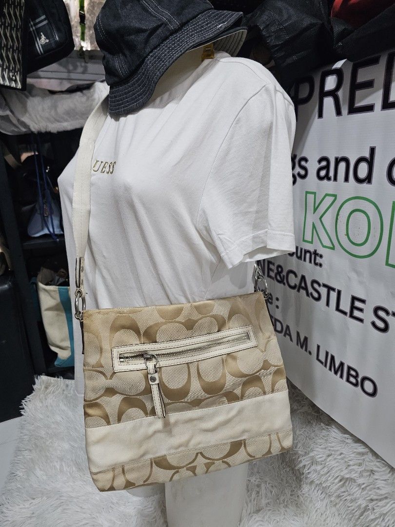 Coach Signature Monogram Canvas Crossbody Bag (Category: Luxury Bags & Wallets) located in Cavite. Submitted by liveriver_514fd1 (Listing ID 1464615921, Image 2). Description: - Authentic Coach monogram canvas shoulder bag - Chic beige and cream colorway - Convenient front zipper pocket - Adjustable strap for comfortable wear - Shows some signs of wear on the lighter colored trim, adding character - Perfectly functional and stylish for everyday u