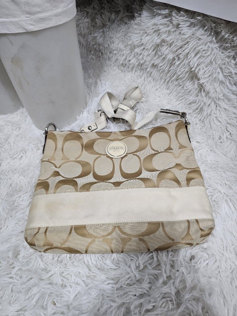 Coach Signature Monogram Canvas Crossbody Bag (Category: Luxury Bags & Wallets) located in Cavite. Submitted by liveriver_514fd1 (Listing ID 1464615921, Image 3). Description: - Authentic Coach monogram canvas shoulder bag - Chic beige and cream colorway - Convenient front zipper pocket - Adjustable strap for comfortable wear - Shows some signs of wear on the lighter colored trim, adding character - Perfectly functional and stylish for everyday u