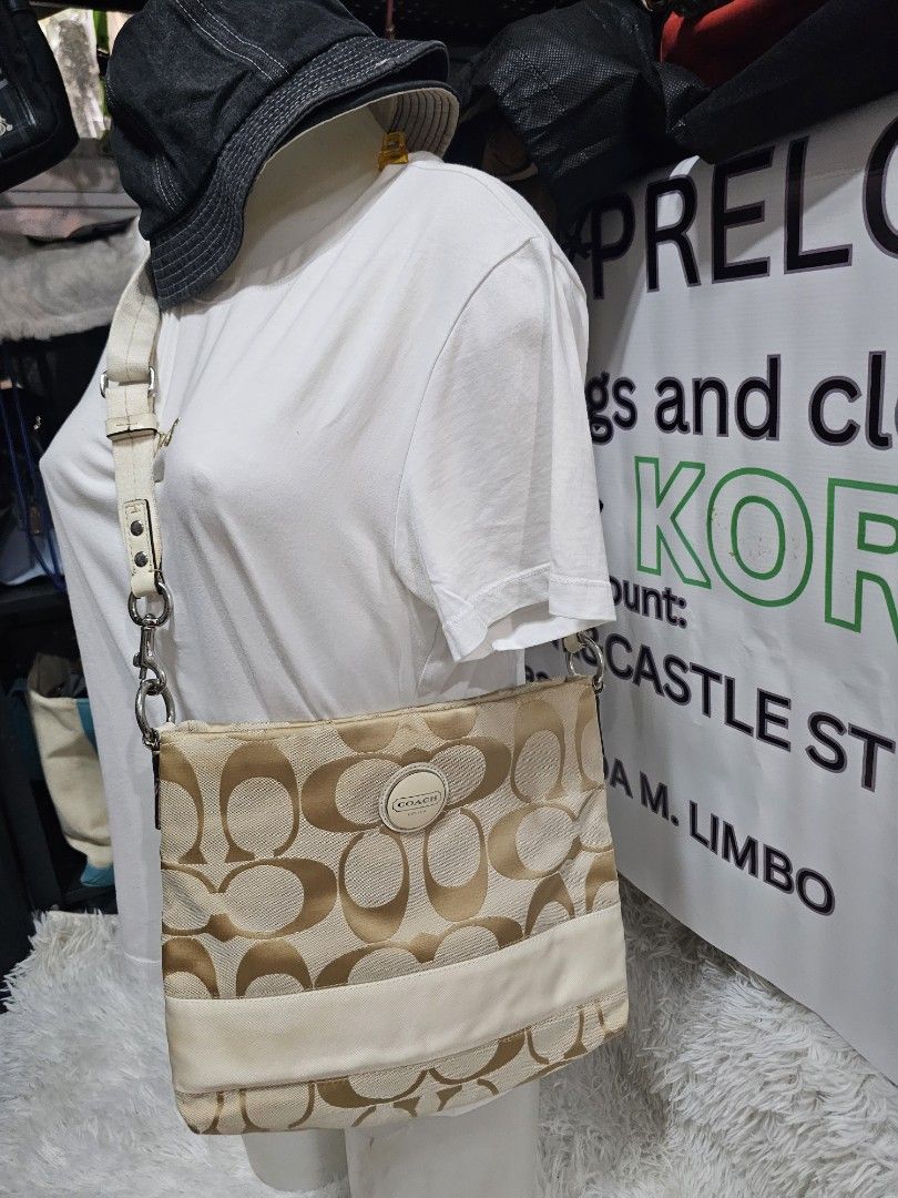 Coach Signature Monogram Canvas Crossbody Bag (Category: Luxury Bags & Wallets) located in Cavite. Submitted by liveriver_514fd1 (Listing ID 1464615921, Image 1). Description: - Authentic Coach monogram canvas shoulder bag - Chic beige and cream colorway - Convenient front zipper pocket - Adjustable strap for comfortable wear - Shows some signs of wear on the lighter colored trim, adding character - Perfectly functional and stylish for everyday u