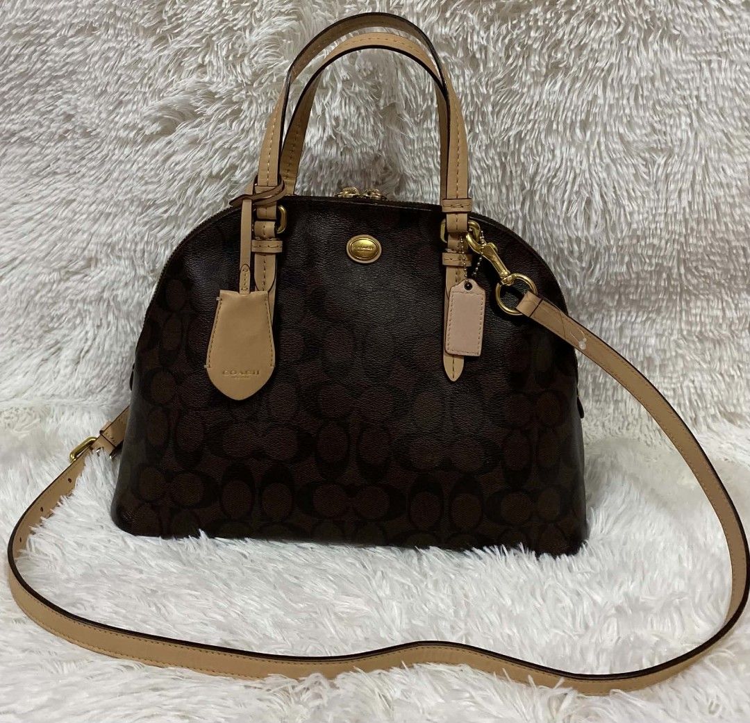 Authentic Coach Signature Monogram Dome Satchel Bag (Category: Luxury Bags & Wallets) located in Manila. Submitted by gutierrez23265 (Listing ID 1464642391, Image 1). Description: - Authentic Coach monogram dome satchel - Color: Brown signature print with tan leather trim - Closure: Top zip - Straps: Double top handles and detachable crossbody strap - Hardware: Gold tone - Includes: Coach hangtag - Ideal for: Everyday use PLS CHECK ALL PHOTOS DET