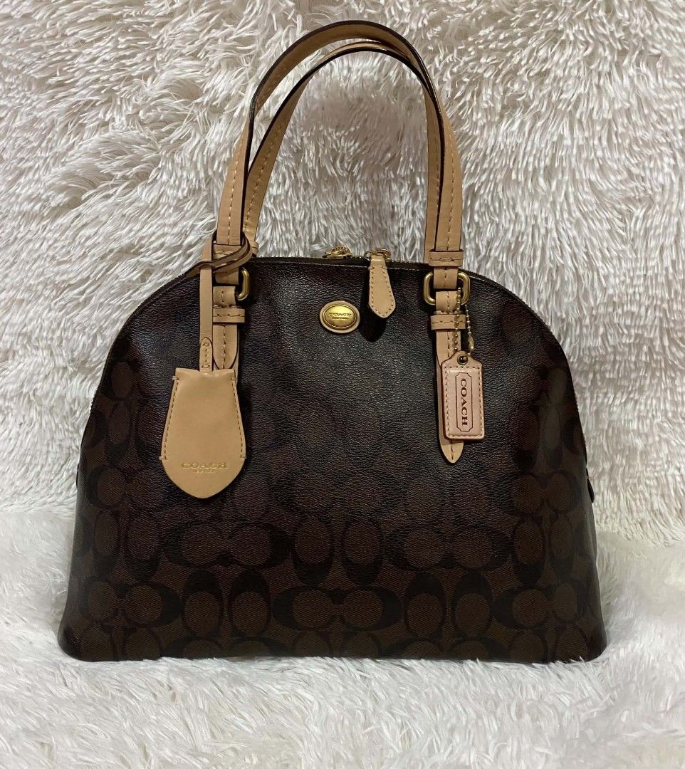 Authentic Coach Signature Monogram Dome Satchel Bag (Category: Luxury Bags & Wallets) located in Manila. Submitted by gutierrez23265 (Listing ID 1464642391, Image 2). Description: - Authentic Coach monogram dome satchel - Color: Brown signature print with tan leather trim - Closure: Top zip - Straps: Double top handles and detachable crossbody strap - Hardware: Gold tone - Includes: Coach hangtag - Ideal for: Everyday use PLS CHECK ALL PHOTOS DET