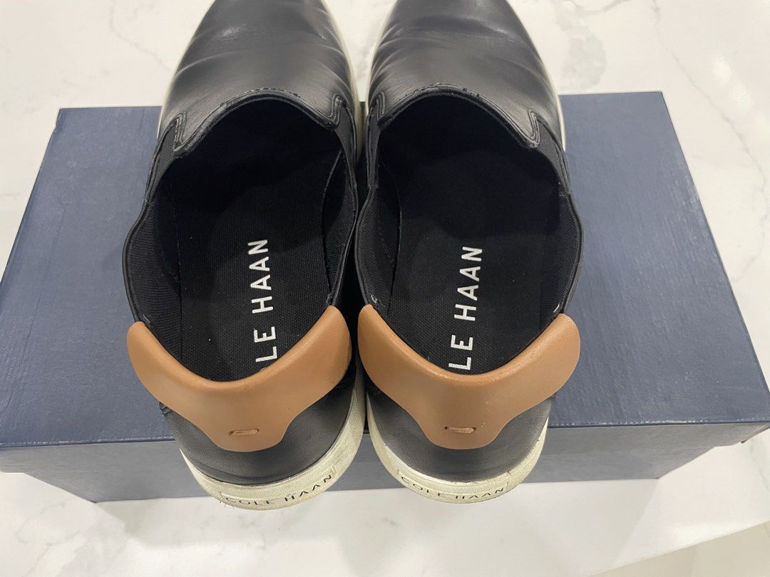 Cole Haan Nantucket 2.0 size 11.5 US (Category: Casual Shoes) located in Pateros City. Submitted by dunhillmenthols (Listing ID 1464653614, Image 2). Description: - Cole Haan black leather slip-on sneakers - Tan accent at the heel - Comfortable elastic side panels for easy on and off - Durable rubber sole - Perfect for casual outings and everyday wear - Shows some signs of use on soles and leather.