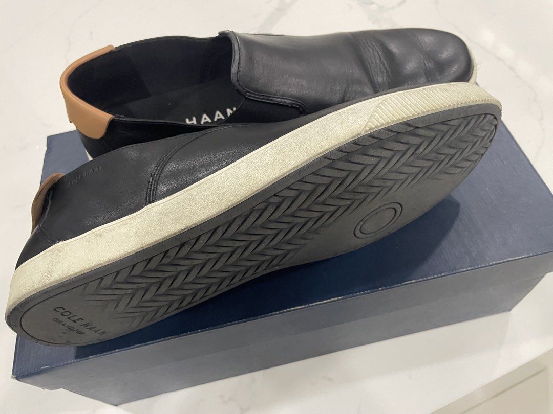 Cole Haan Nantucket 2.0 size 11.5 US (Category: Casual Shoes) located in Pateros City. Submitted by dunhillmenthols (Listing ID 1464653614, Image 3). Description: - Cole Haan black leather slip-on sneakers - Tan accent at the heel - Comfortable elastic side panels for easy on and off - Durable rubber sole - Perfect for casual outings and everyday wear - Shows some signs of use on soles and leather.
