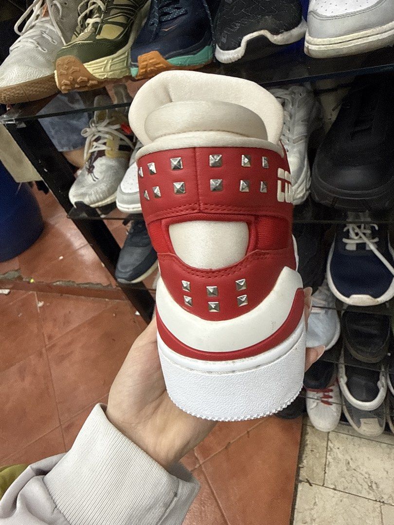 Converse CONS Red White Studded High Top Sneakers (Category: Sneakers) located in Manila. Submitted by fastlion.584bdf (Listing ID 1464732477, Image 2). Description: - Brand/Model: Converse CONS - Color: Red and white with metal stud details on the side and heel - Style: High top with chunky sole and white laces - Size: Men's 8 / Women's 9.5 / EUR 41 / 260 mm - Materials: Leather upper, textile lining, rubber outsole - Origin: Made in Vietnam.