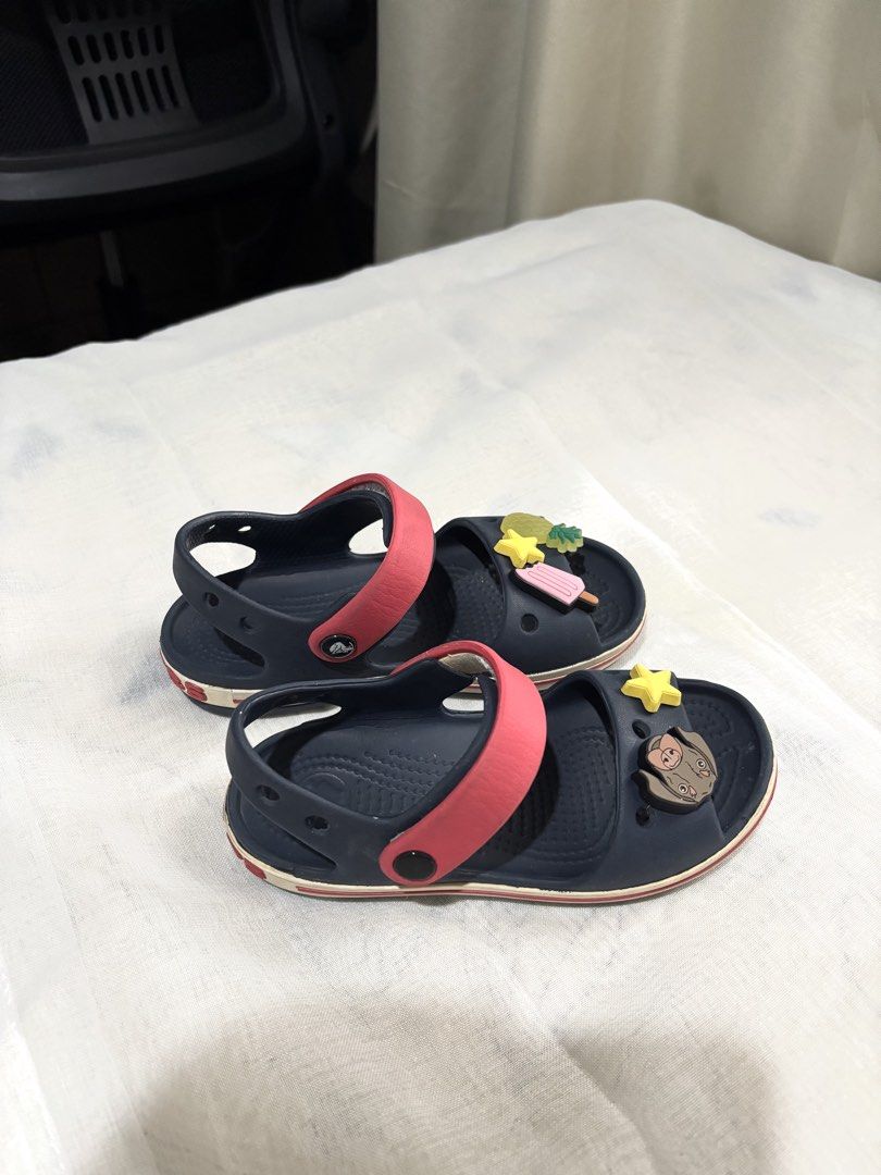 Crocs Kids Size 11 (4-6 yrs old) (Category: Babies & Kids Fashion) located in Calamba. Submitted by marbautista (Listing ID 1464632979, Image 2). Description: - Navy blue Crocs with Jibbitz charms, size 11. - Suitable for children aged 3-6 years old. - Durable, ideal for daily wear and playtime Visible signs of usage, but in very good condition.