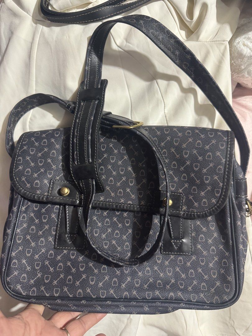 Crossbody bag why 100% leather (Category: Luxury Bags & Wallets) located in Manila. Submitted by wildbear.e10374 (Listing ID 1464735565, Image 1). Description: - Color/Design: Dark blue with allover horsebit print - Hardware: Brass tone with matching hanging debossed leather tag - Closure: Secure flap with snap buttons - Strap: Adjustable for custom fit - Interior: Fabric lining, zippered pocket, and inner gold branding plate - Condition: Minor w