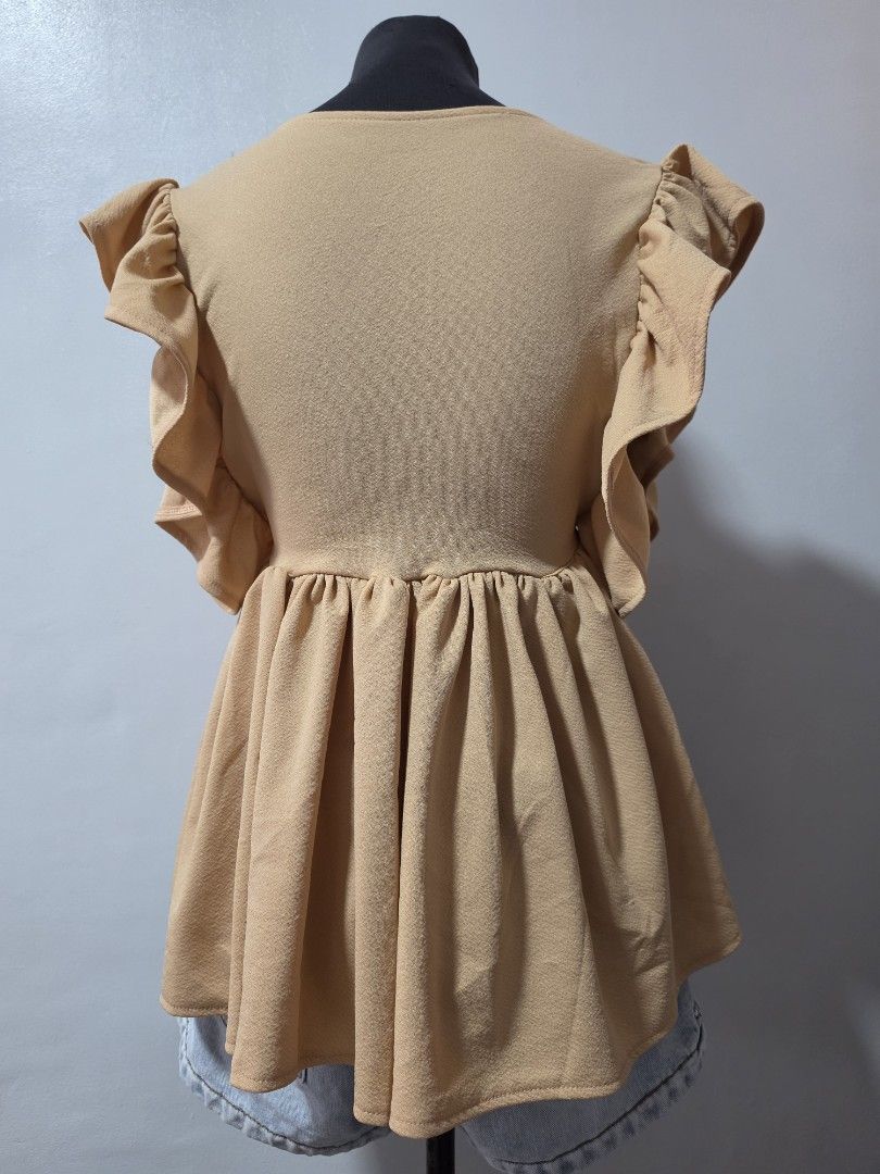 Cute Beige Ruffle Wrap Top with Tie Detail medium (Category: Blouses) located in Paranaque City. Submitted by franinnashop (Listing ID 1464639454, Image 3). Description: - Chic beige top - Ruffled sleeves and neckline - Adjustable front tie for a cinched waist - Flowy, gathered hem - Versatile for pairing with jeans or shorts - Comfortable and stylish for casual outings declutter medium to large paranque city.
