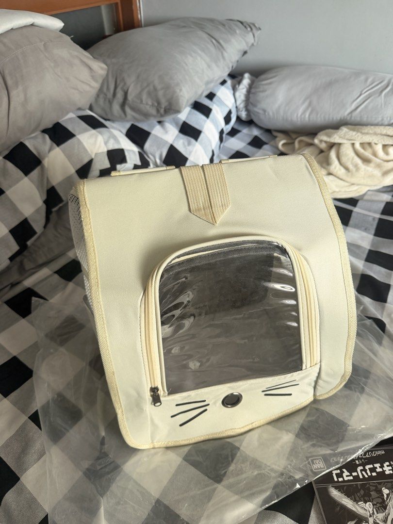 Cute Cat Face Pet Carrier Backpack for Small Animals (Category: Backpacks) located in Manila. Submitted by ellede32655 (Listing ID 1464618790, Image 1). Description: - Cream-colored pet carrier backpack - Features a clear front window with a cute cat face design - Zips open for easy pet access - Adjustable straps for comfortable carrying - Ideal for small pets on the go - Approximately 13 inches tall.