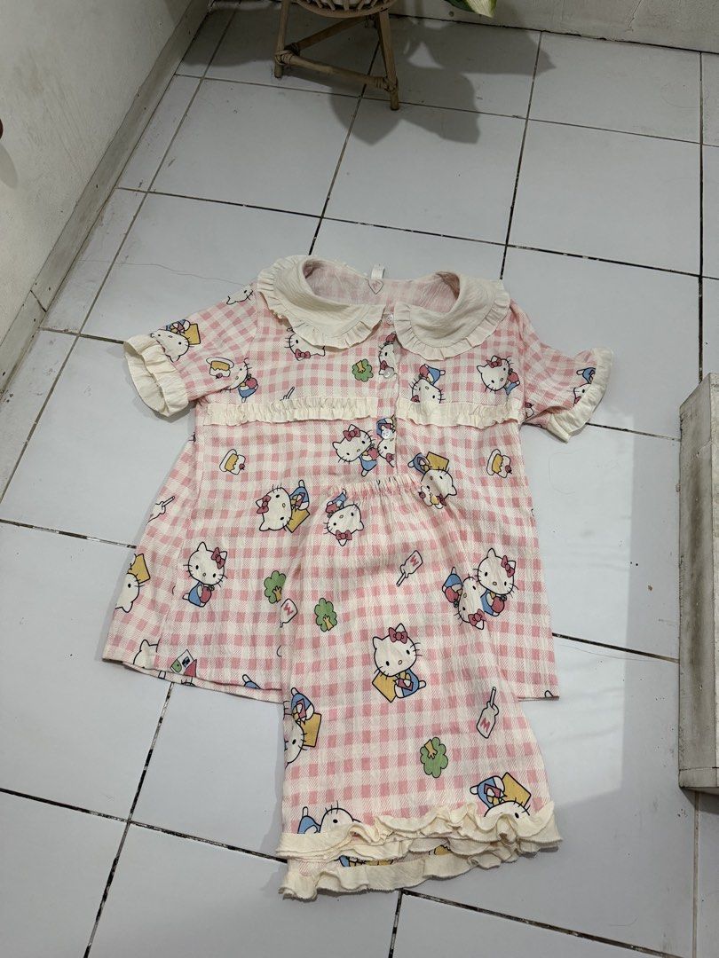 Cute Pink Gingham Hello Kitty Pajama Set (Category: Undergarments & Loungewear) located in Marikina City. Submitted by feibella_clothing24 (Listing ID 1464671023, Image 1). Description: - Adorable pink gingham pajama set - Features a cute Kitty print - Ruffled collar and hem - Short sleeves and shorts for comfort - Ideal for Kitty fans, sleeping, or lounging may pads na premium po .