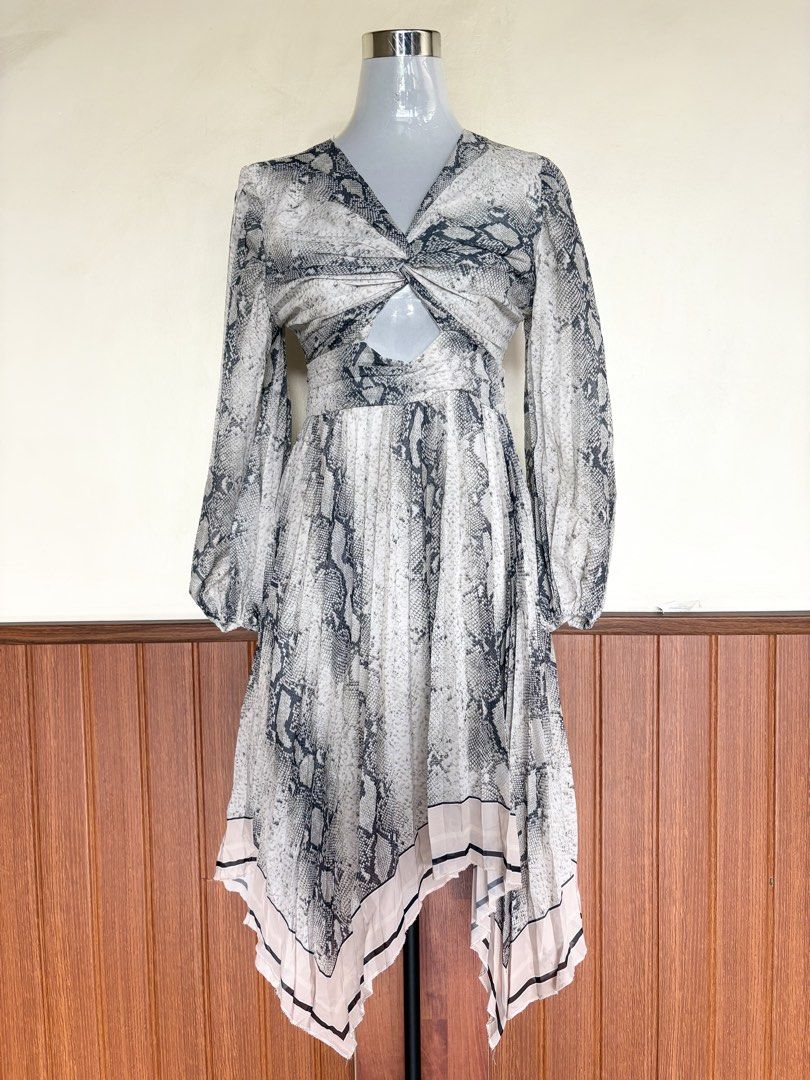 Cutout Pleated Silk Asymmetric Python Print Dress (Category: Dresses) located in Cebu City. Submitted by stylingtrends.coll (Listing ID 1464642750, Image 2). Description: - python print silk asymmetric dress - Flattering cut-out detail - Stylish twisted front and long balloon sleeves - Pleated skirt with a handkerchief hem and subtle pink trim - Open back with a secure tie closure - Ideal for parties, dates, or any special event Size: Small-Semi 