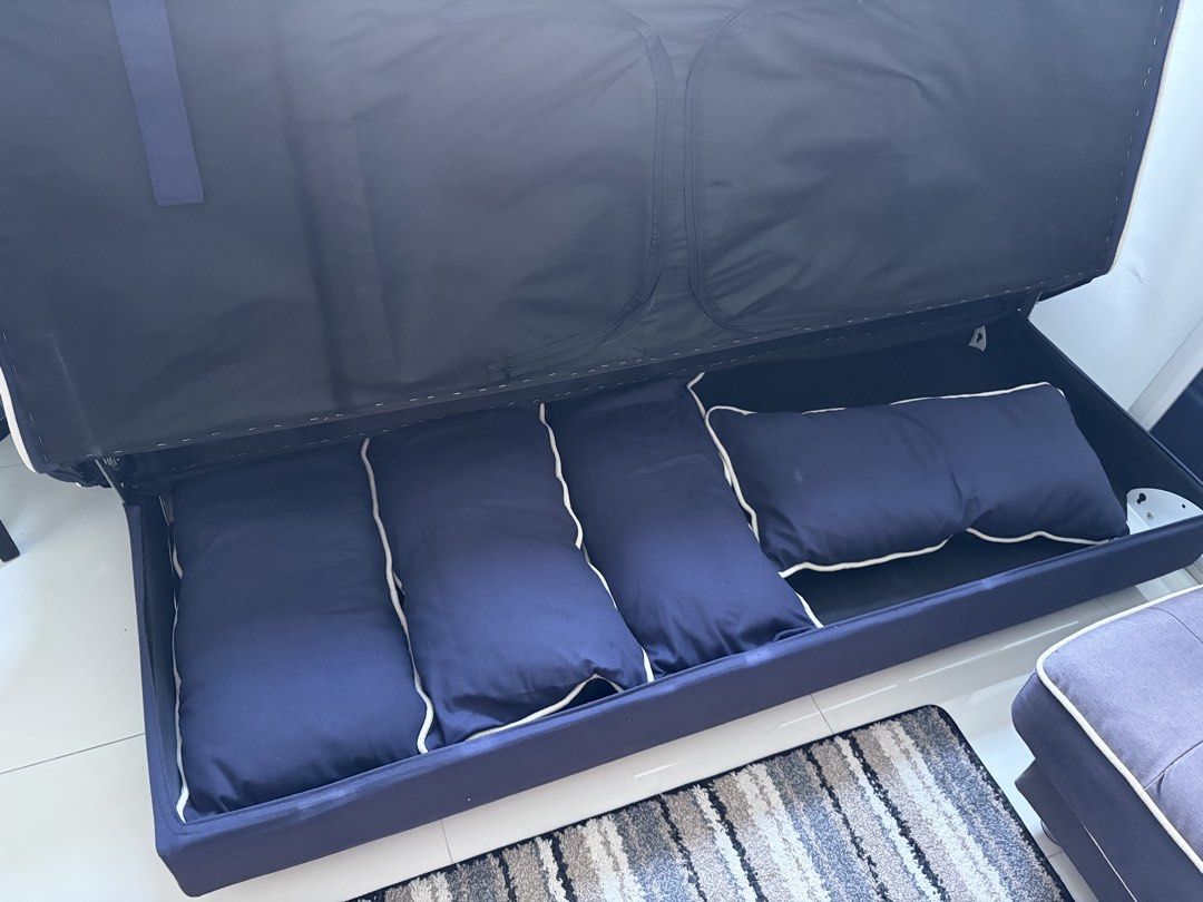 Dark Blue Sofa Bed with Storage (Category: Sofas) located in Manila. Submitted by kyneesha8 (Listing ID 1464685802, Image 2). Description: - Convertible sofa bed - Comes with matching pillows - Ample hidden storage space underneath - Ideal space-saving solution for apartments and small rooms - Effortlessly transforms from a sofa to a comfortable bed.
