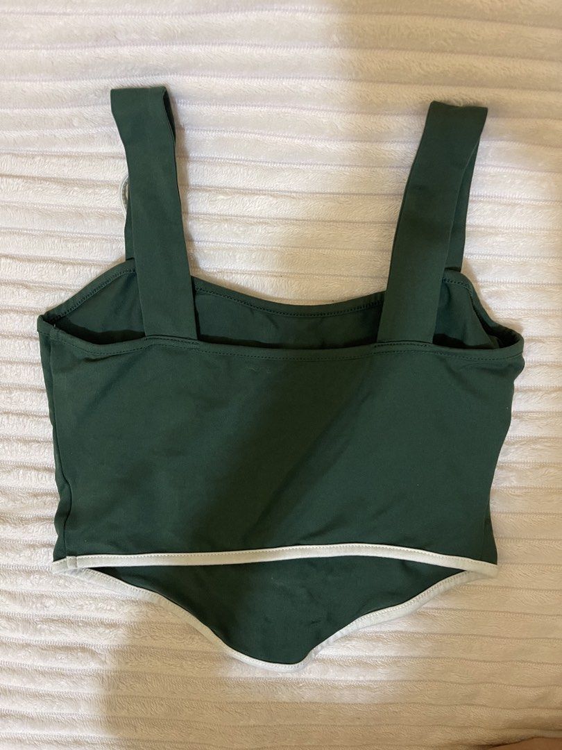 Dark Green Graphic Corset Crop Top (Category: Others Tops) located in Manila. Submitted by rare.yurichi (Listing ID 1464738218, Image 3). Description: Deep forest green top featuring white “URBANE” text and a circular “Dream Everything Always EST. 1980” graphic emblem. Designed with a curved corset-style pointed hem, contrasting white trim, and adjustable shoulder tie straps..