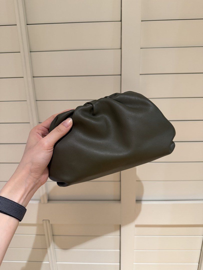 Dark Green Leather Pouch Clutch Bag (Category: Clutches) located in Manila. Submitted by decluttersiris (Listing ID 1464593168, Image 1). Description: - Soft dark green leather pouch clutch - Relaxed gathered top closure - Ample space for essentials - Small marks on metal clasp area - Versatile for casual outings or evenings out.