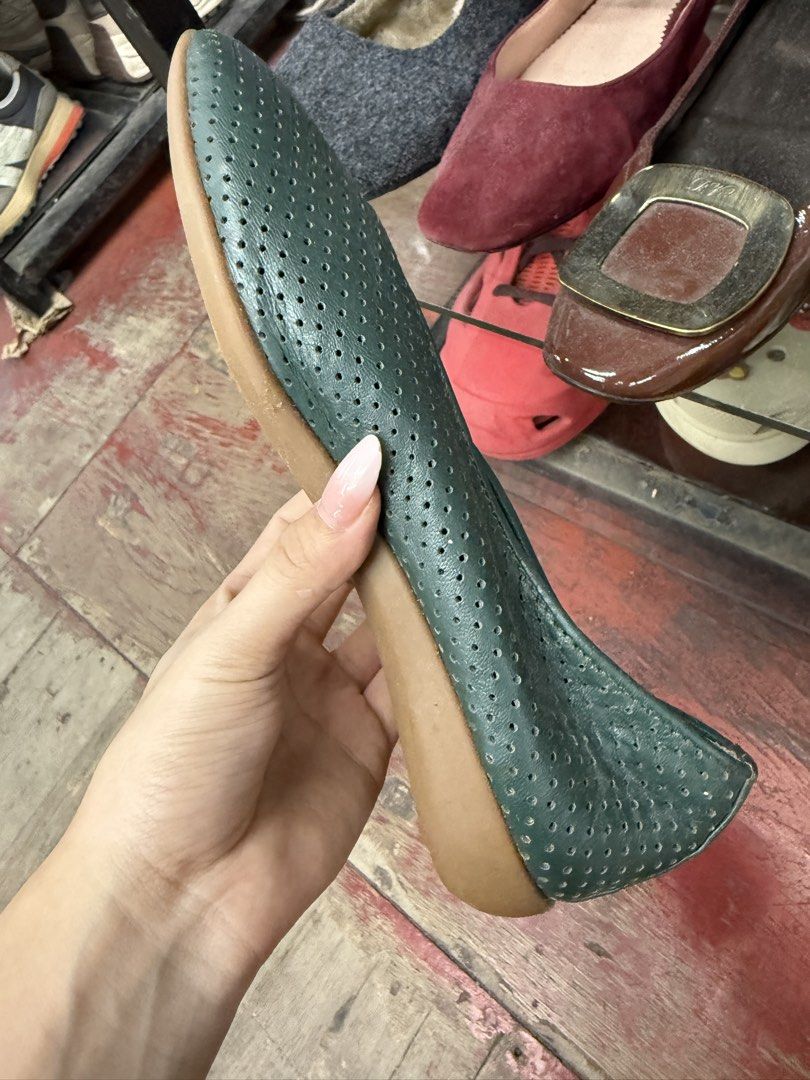 Dark Green Perforated Leather Slip-On Flats (Category: Flats & Sandals) located in Manila. Submitted by fastlion.584bdf (Listing ID 1464733507, Image 2). Description: - Color: Versatile dark green - Material: Soft leather with all-over perforated holes for maximum breathability - Design: Foldable and slip-on style, perfect for travel and easy packing - Sole: Flat rubber sole for all-day walking comfort - Style: Minimalist look that pairs effortle