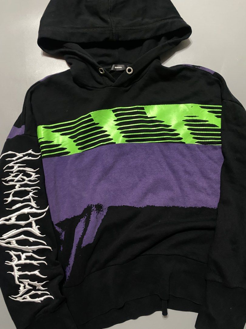 Diesel Black Graphic Hoodie (Category: Hoodies) located in Silang. Submitted by kenneth_ukays (Listing ID 1464577169, Image 3). Description: - Black Diesel hoodie - Bold graphic print on front and back - Contrasting green and purple stripes - Unique distressed graphic on sleeves - Comfortable and stylish for everyday wear - Great statement piece.