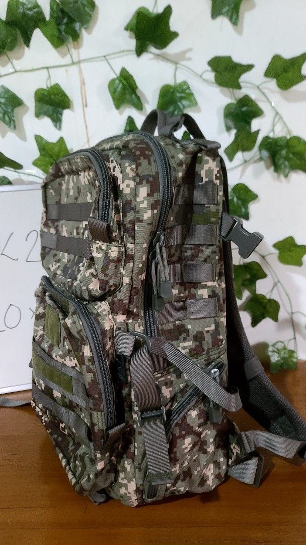 Digital Camouflage Tactical Backpack Molle Outdoor Bag (Category: Backpacks) located in Baguio. Submitted by phoeberose33384 (Listing ID 1464765477, Image 2). Description: - Digital camouflage tactical backpack measuring approx. 20" x 13" - Multiple spacious compartments with heavy-duty zippers - Molle webbing on front and sides for extra attachments - Padded mesh shoulder straps with adjustable buckles and cross sternum strap for comfort - Velcr