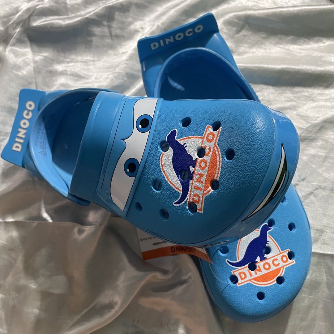 Dinoco Crocs ( M8/W10) (Category: Slippers & Slides) located in Makati City. Submitted by declutterwithann_ (Listing ID 1464611228, Image 1). Description: Brand New Local Release with Receipt Size M8/W10 🏷️P6k 📍 Taguig.