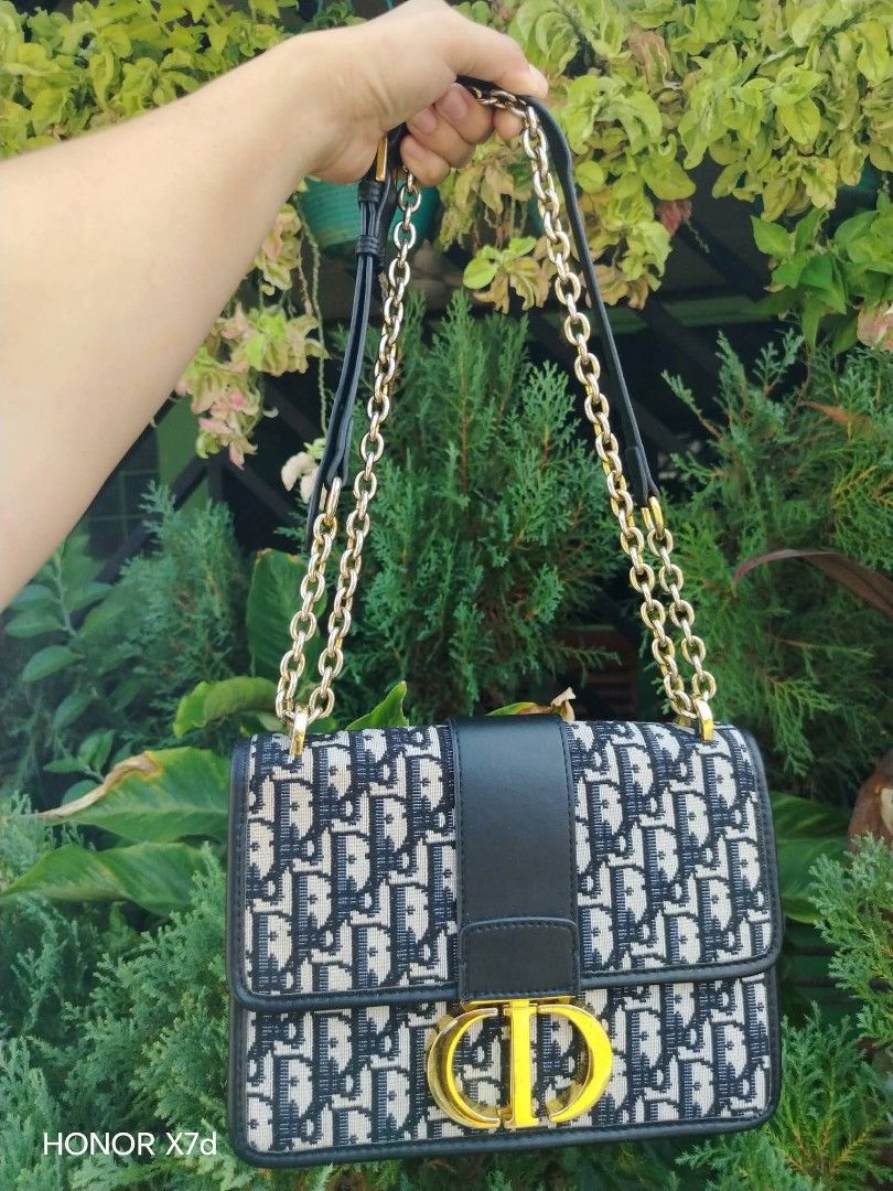 Dior Oblique Canvas & Leather Flap Bag (Category: Luxury Bags & Wallets) located in Manila. Submitted by nikkaverda42241 (Listing ID 1464578462, Image 1). Description: - Classic Dior flap bag - Iconic Oblique canvas with black leather trim - Gold-tone CD clasp closure - Chain strap with leather shoulder pad - Interior zip pocket - Versatile for day or night use.