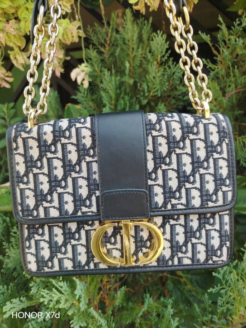 Dior Oblique Canvas & Leather Flap Bag (Category: Luxury Bags & Wallets) located in Manila. Submitted by nikkaverda42241 (Listing ID 1464578462, Image 2). Description: - Classic Dior flap bag - Iconic Oblique canvas with black leather trim - Gold-tone CD clasp closure - Chain strap with leather shoulder pad - Interior zip pocket - Versatile for day or night use.