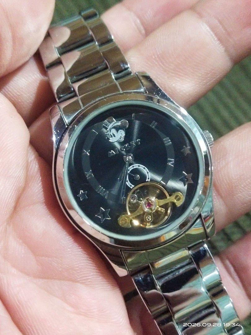 Disney Mickey Mouse Mechanical Manualwinding (Category: Men's Watches) located in Tuba. Submitted by drickbernard (Listing ID 1464687879, Image 2). Description: - Cool Mickey Mouse watch by Time Concepts - Black dial with stars and Roman numerals - Good working condition - Manualwinding - Durable stainless steel band - Ideal for any Disney fan - unisex @34mm case size fits UpTo 6.5" wrist .
