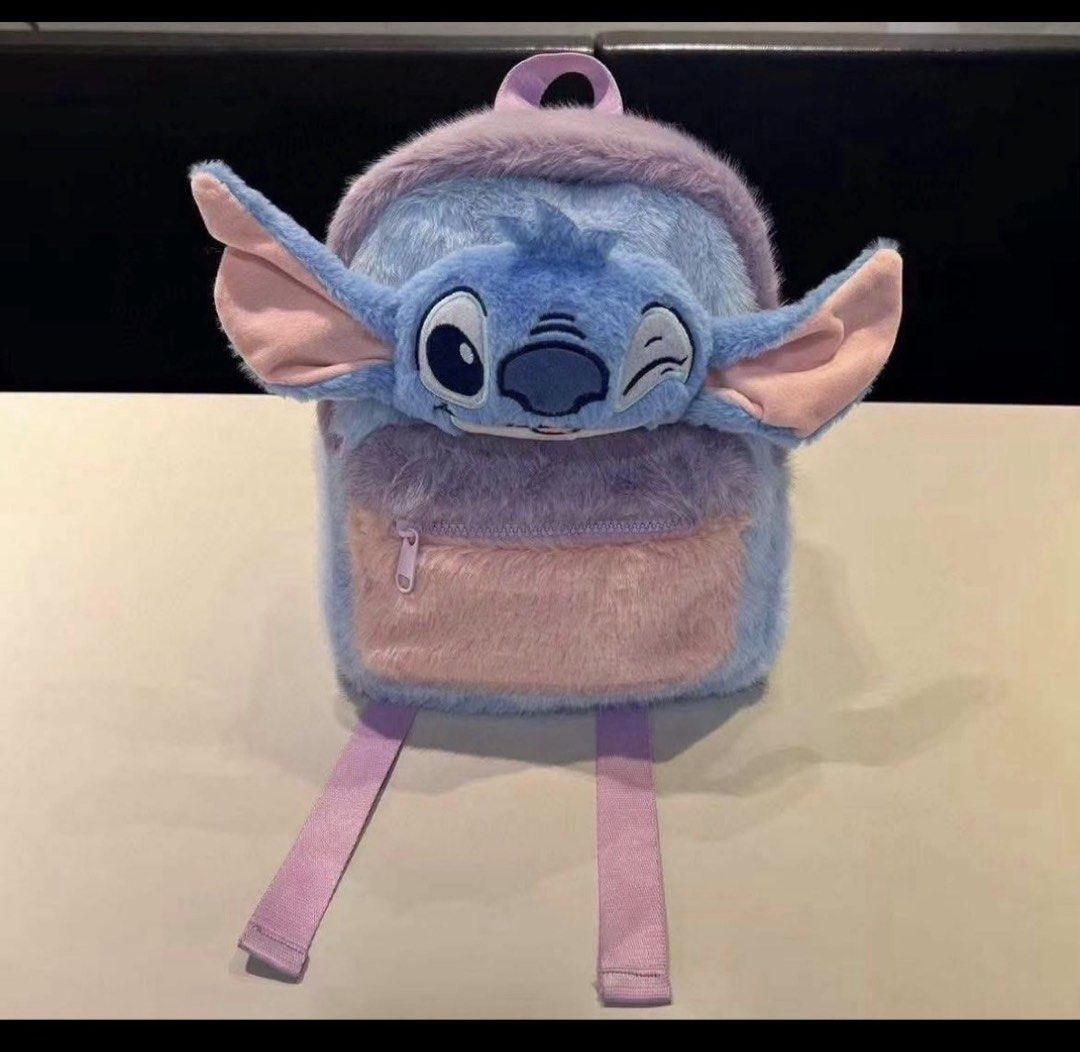 Disney Stitch Fluffy Plush Backpack (Category: Plushies & Soft Toys) located in Manila. Submitted by rkmvillarosa (Listing ID 1464706125, Image 1). Description: - Adorable Stitch character design with 3D ears - Made from ultra-soft, fuzzy blue and purple material with cute pink ear accents - Convenient front zipper pocket for small essentials - Comfortable, adjustable purple back straps.