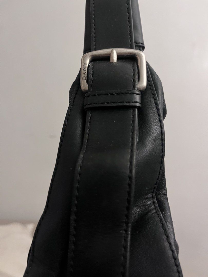 DKNY Black Leather Shoulder Bag (Category: Luxury Bags & Wallets) located in Baguio. Submitted by ellebuys (Listing ID 1464607497, Image 2). Description: - DKNY black leather shoulder bag - Top zip closure - Interior zip pocket and slip pocket - Silver hardware details - Adjustable buckle straps - Spacious interior for essentials - Ideal for everyday use.