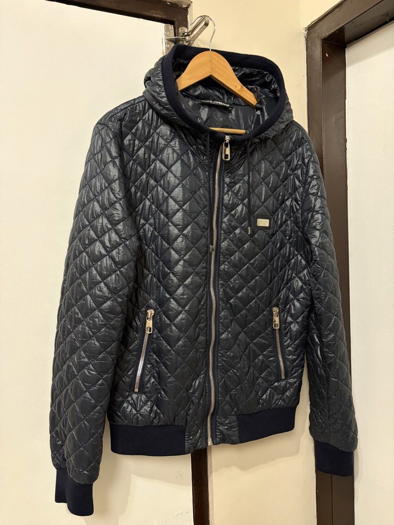 DOLCE & GABANNA 2000s HOODED QUILTED PUFFER JACKET (Category: Coats, Jackets and Outerwear) located in Cavite. Submitted by frankiemnla (Listing ID 1464630141, Image 1). Description: L- 28 W- 21 Size- Med to Large Like new condition Pattern: Classic, fine diamond-quilted pattern throughout the exterior shell. Hardware: Exposed silver-tone metallic zippers on the main front closure and the vertical side pockets. Details: Integrated fabric hood wit