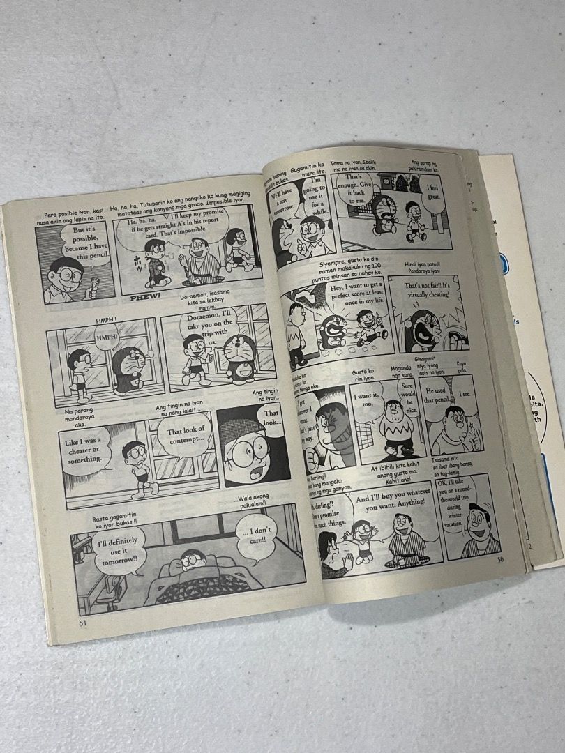 Doraemon Gadget Cat from the Future Volume 1 English Tagalog Comic (Category: Comics & Manga) located in Caloocan City. Submitted by rdtrmt (Listing ID 1464672103, Image 3). Description: - Shogakukan English Comics: Doraemon - Volume 1: The Gadget Cat from the Future - Story: A robot cat from 2112 travels back in time to help Nobita. - Features: Utilizes the magical 4-D Pocket for secret tools. - Author: Fujiko F. Fujio - The item is slightly use