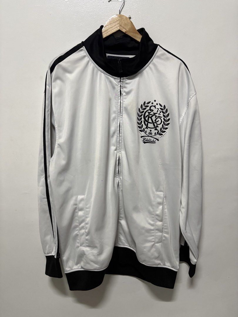 Ecko Unltd Track Jacket White Black Size 2XL (Category: Coats, Jackets and Outerwear) located in Manila. Submitted by skeletal_v2 (Listing ID 1464743269, Image 1). Description: ECKO UNLTD- 1000+SF 25/30 GOOD CONDITION COLOR RATE 9/10 STAIN - Brand: Ecko Unltd - Style: Full-zip track jacket - Color: White and black with contrast stripes - Size: Tagged 2XL - Material: 100% polyester - Features: Stand-up collar, side pockets, bold printed graphic lo